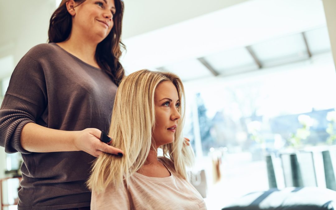 Young woman talking with her hairstylist in a salon